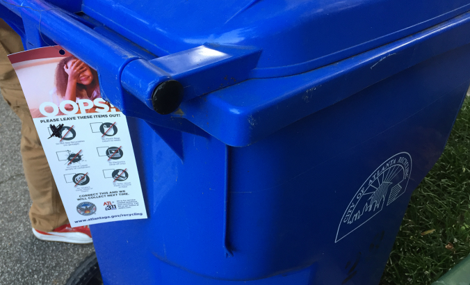 Recycling bin in the City of Atlanta with tag that details items to leave out