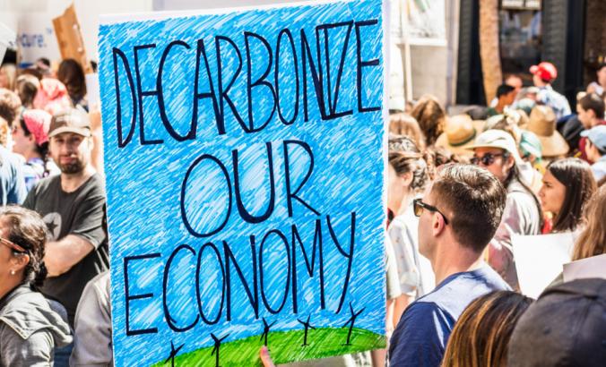 Decarbonize our economy placard raised at the Global Youth Climate Strike Rally and March in downtown San Francisco