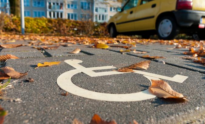 Disabled parking sign painted in parking spot