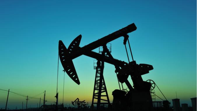 Oil rig with blue-green sunset in background